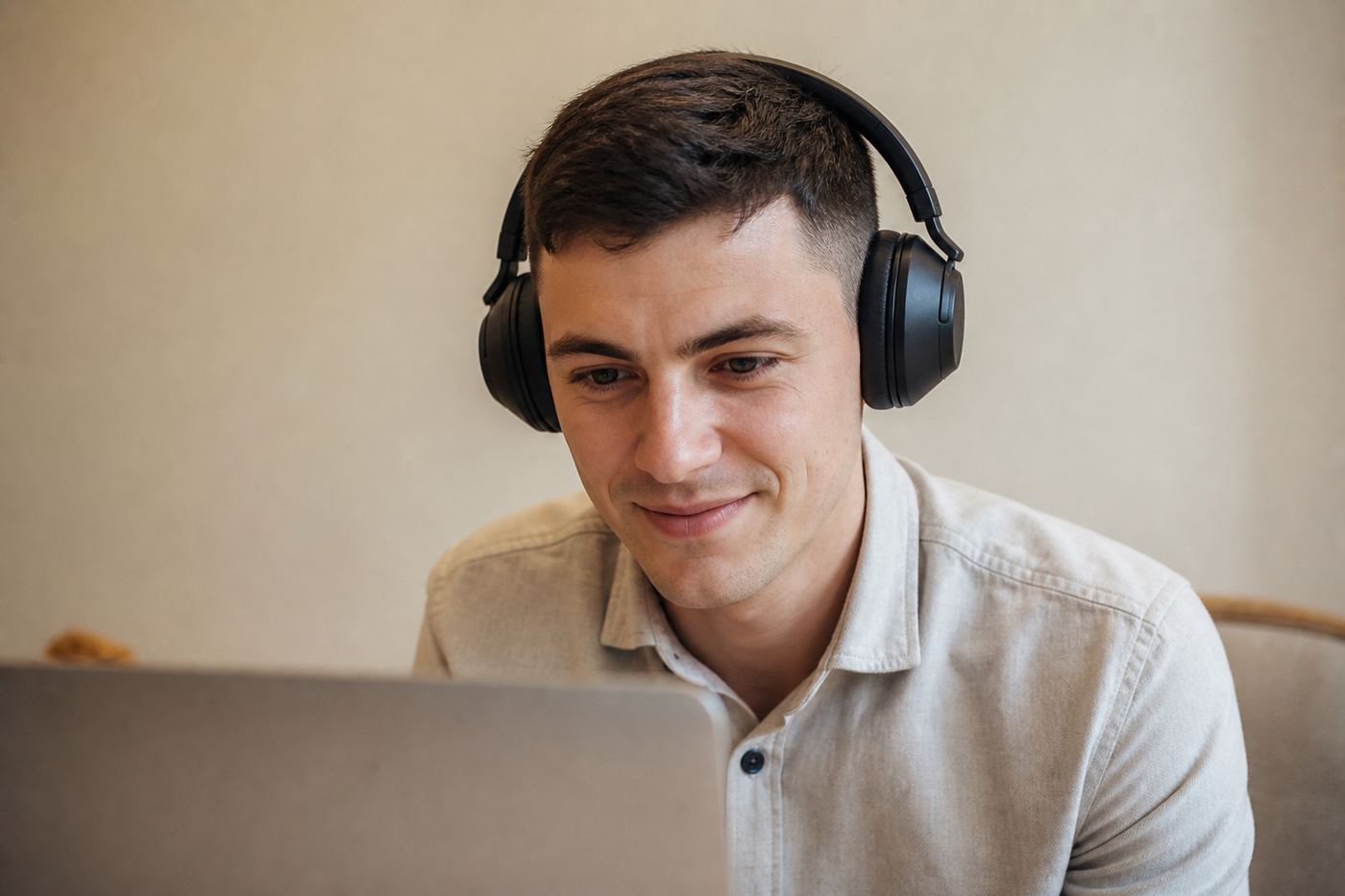 Young man with headphones working on a laptop